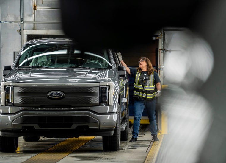 Suzie Roskandich-McDermott looks over a Ford F-150 Lightning pickup truck at the Rouge Electric Vehicle Center in Dearborn, Mich.