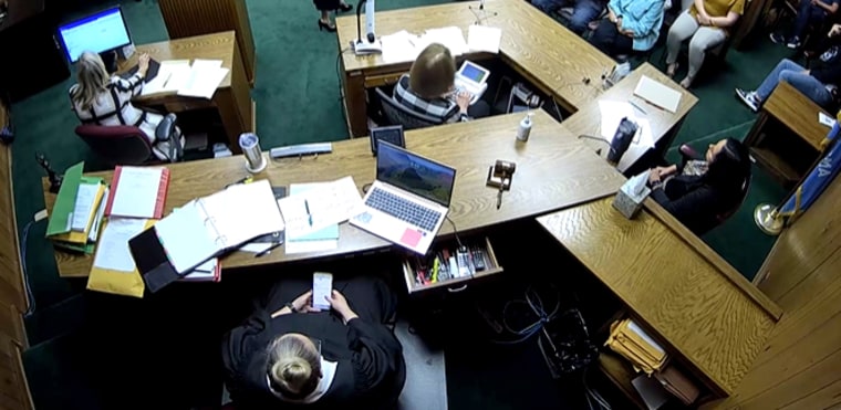 Judge Traci Soderstrom, bottom, looks at her phone while in court on June 7, 2023.