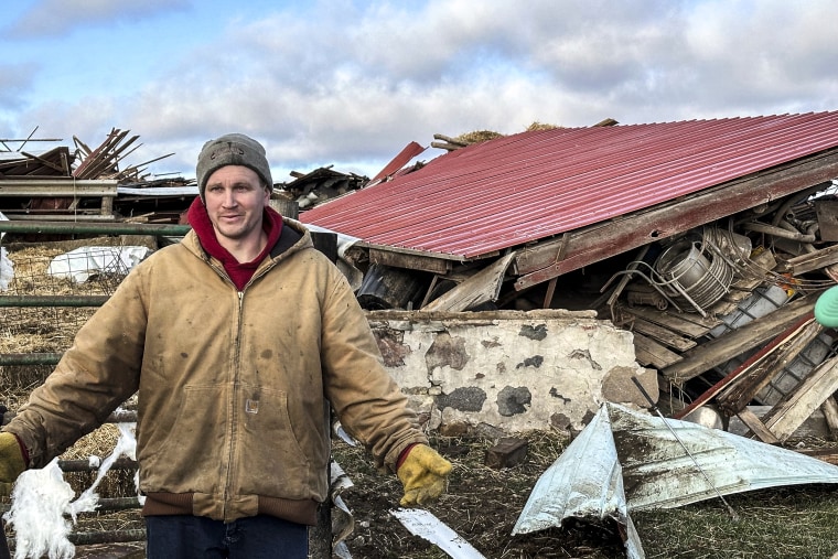 Image: Matt Artis, 34, surveys the wreckage on Feb. 9, 2024, after a tornado struck his farm in the Town of Porter, Wis., 