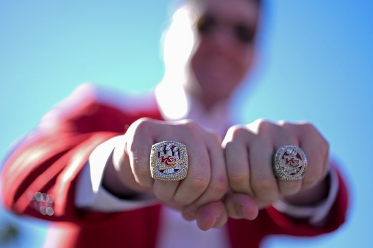 A Kansas City Chiefs fan shows off Super Bowl rings.