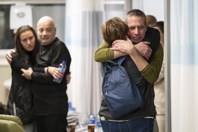 Hostages Fernando Simon Marman (right) and Luis Har, second from left, hug relatives after being rescued from captivity in the Gaza Strip, at the Sheba Medical Center in Ramat Gan, Israel, Monday, February 12, 2024. 