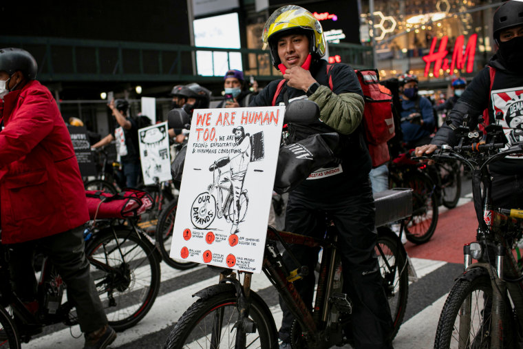 Food delivery workers take part in protest ride demanding better working conditions, pay and protections in New York
