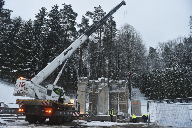 Workers dismantle the memorial of the Red Army Soldiers who died during the liberation of Vilnius from Nazi invaders at the Antakalnis Memorial Cemetery in Vilnius, Lithuania, on Dec. 7, 2022. 
