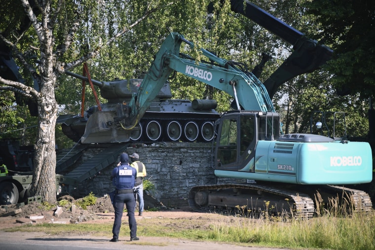 Workers remove a Soviet T-34 tank installed as a monument in Narva, Estonia, on Aug. 16, 2022. 