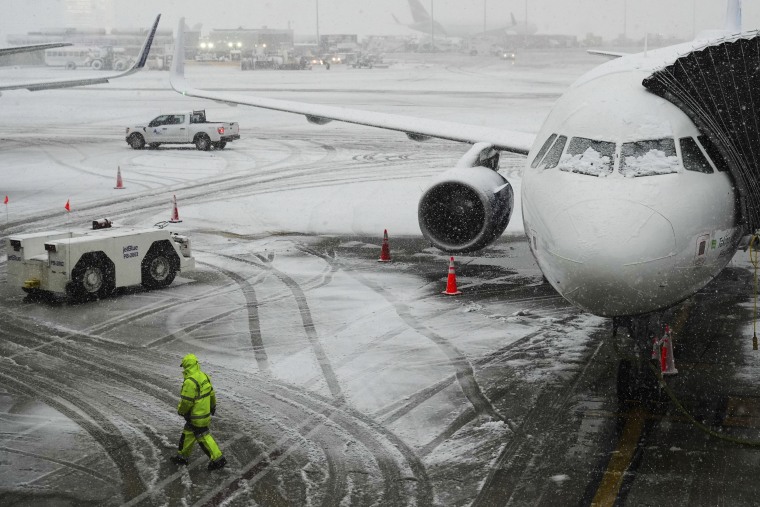 Snow falls at John F. Kennedy International Airport Tuesday, Feb. 13, 2024, in New York.