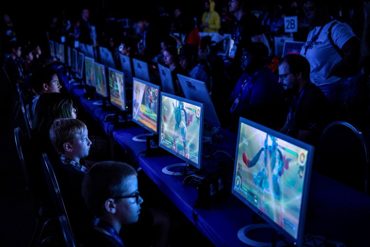 Competitors play a video game at the Washington Convention Center 