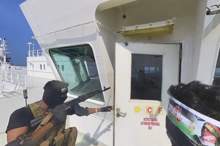 A photo released by the Houthi Media Center shows Houthi forces boarding the cargo ship Galaxy Leader in the Red Sea on Nov. 19, 2023. 