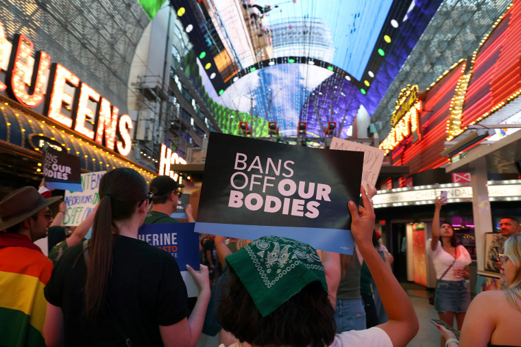 A protester holds a sign that reads, " Bans off our bodies" during a march.