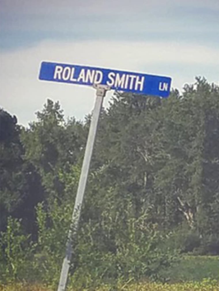A street sign reads Roland Smith Lane.