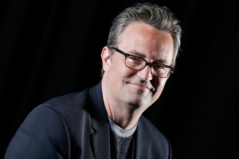 Matthew Perry smiles as he poses for a photograph.