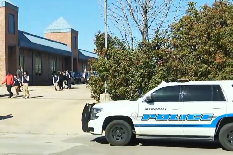 Students walk out of Pioneer Technology & Arts Academy in Mesquite, Texas, on Monday.