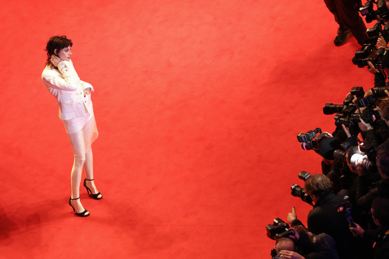 Kristen Stewart poses for photographs on the red carpet.