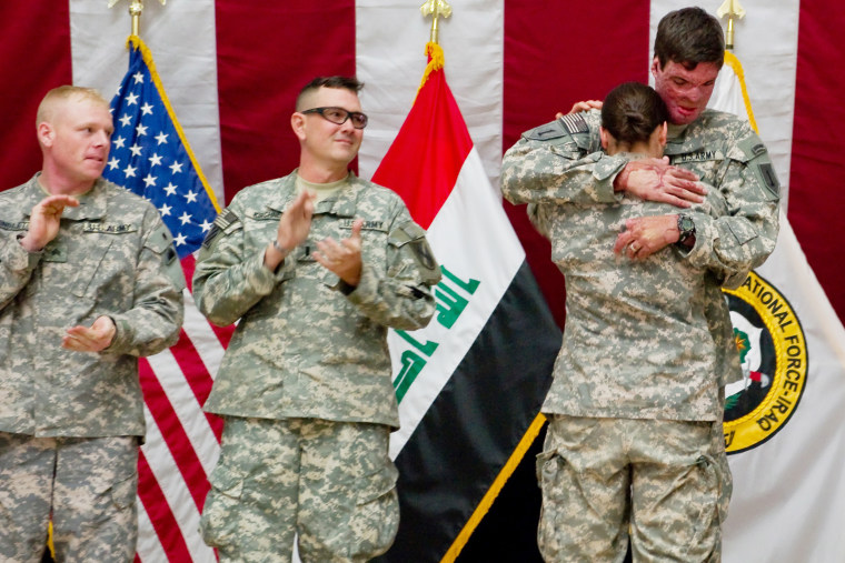 Capt. Sam Brown hugs his wife, Capt. Amy Brown, after arriving in Baghdad to take part in Operation Proper Exit. 