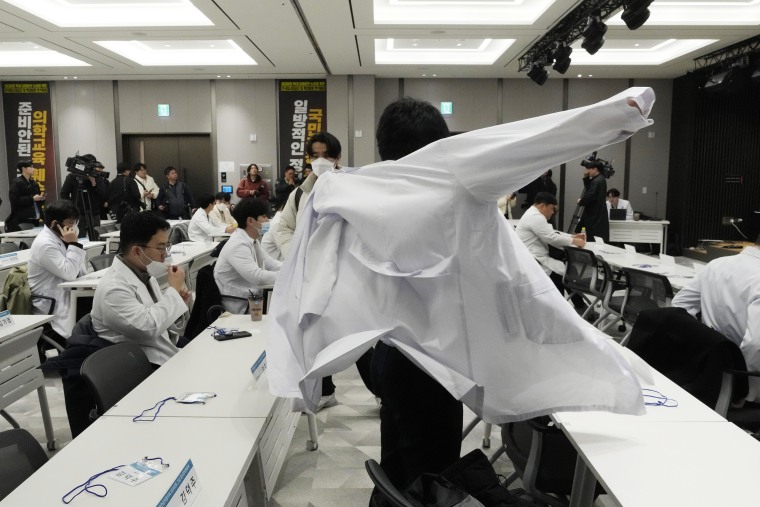 South Korean trainee doctors collectively walked off their jobs Tuesday to escalate their protest of a government medical policy, triggering cancellations of surgeries and other medical treatments at hospitals. 