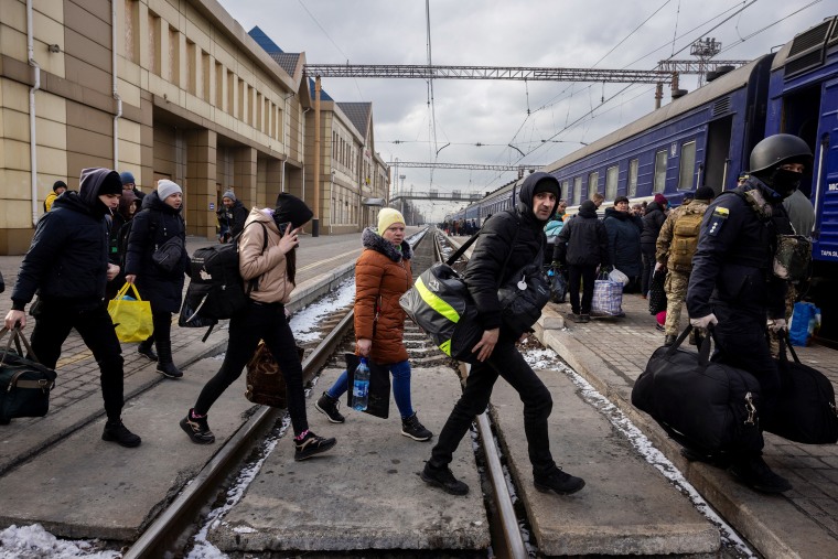 People arrive at Pokrovsk train station to board an evacuation train