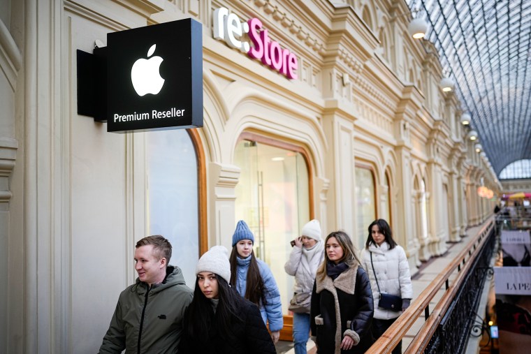 Customers walk past retail outlet "re:Store", an Apple Premium reseller shop, inside the Moscow GUM State Department store in Moscow on March 13, 2023.