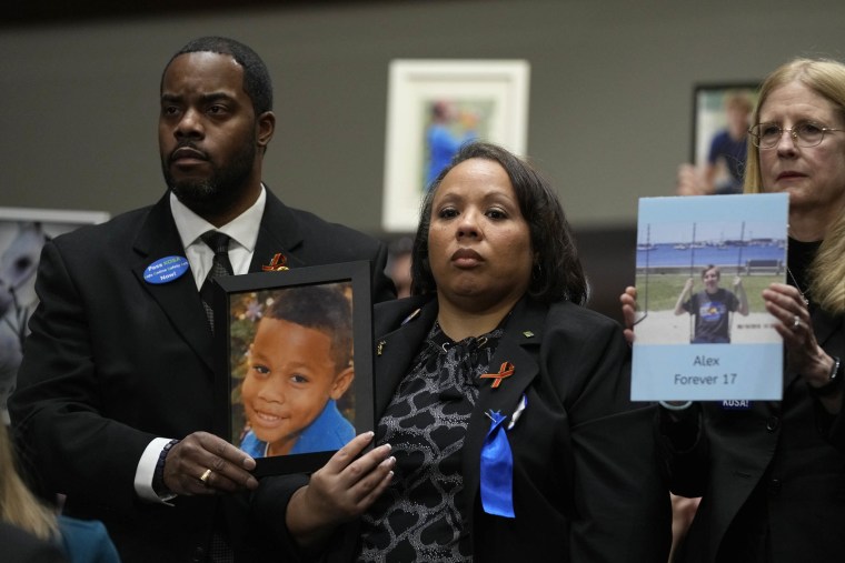 Todd and Mia Minor, both of Accokeek, Md., left, hold a photo of their son, Matthew Minor as they attend a Senate Judiciary Committee hearing with the heads of social media platforms on Capitol Hill on Jan. 31, 2024, on child safety.