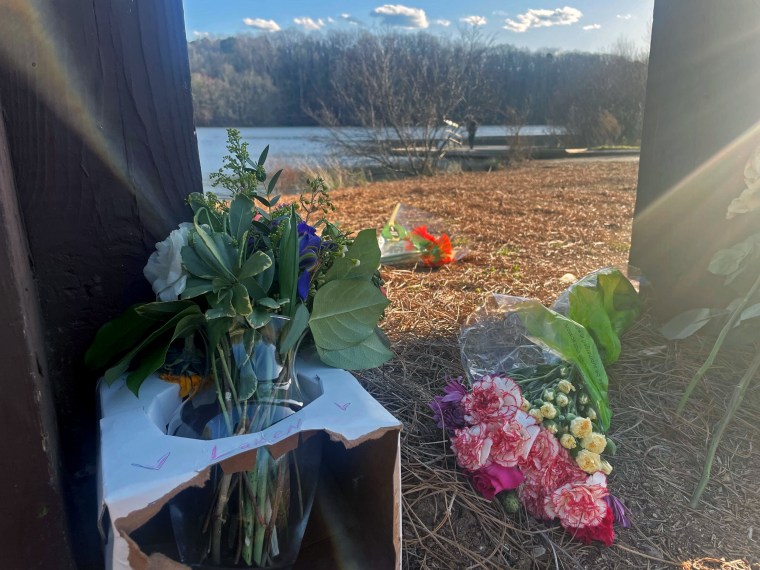 Flowers placed at a UGA campus memorial at Lake Herrick in Georgia.