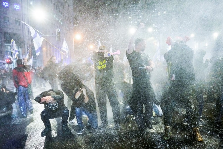 Police use water cannons to disperse demonstrators