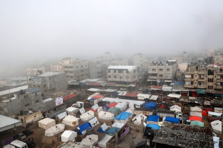 Fog covers buildings and tents set up by displaced Palestinians in Rafah, Gaza, on Sunday.