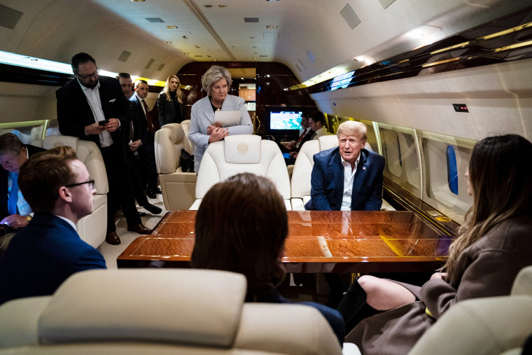 onald Trump speaks with Susie Wiles, center, staff and reporters while flying home on his airplane