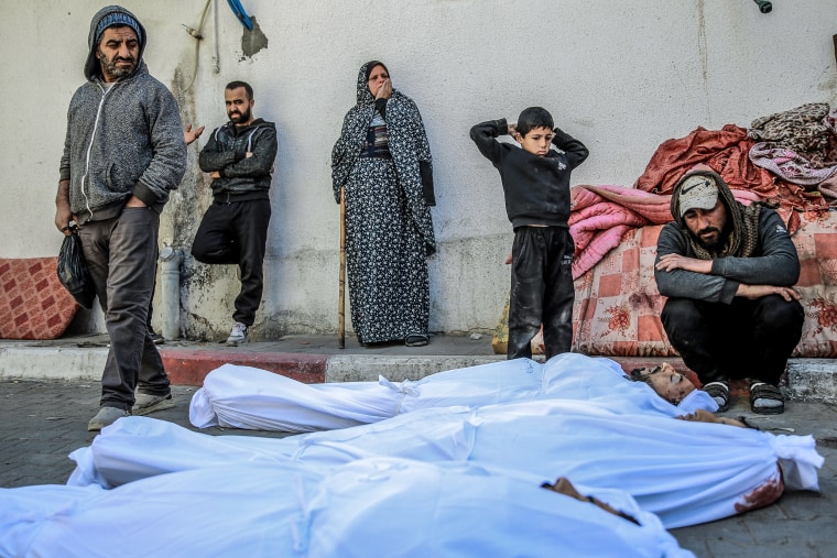 Image: People mourn at Al-Shifa hospital in Gaza City