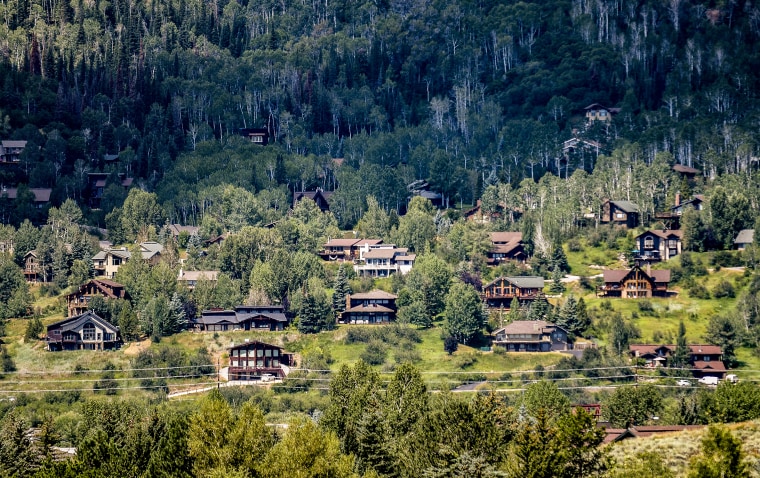 Houses dot a hillside in Steamboat Springs, Colo.,