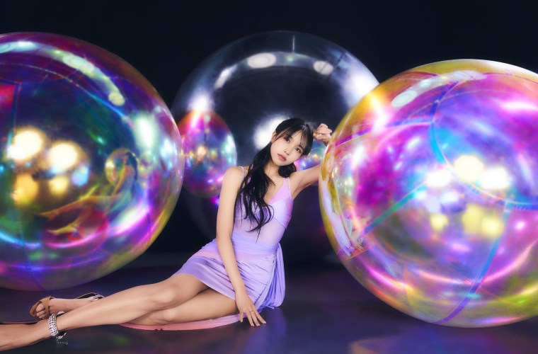 Bright photo shoot with TWICE member, mina posing with giant and small shaped balloons on a dark background