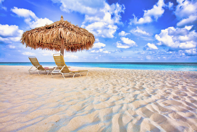 Two Lounge Chairs and Beach Umbrella on a White Sandy Beach in Aruba