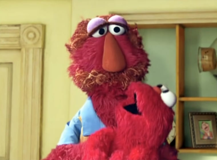 Louie "swings" Elmo around the room in "Sesame Beginnings." 
