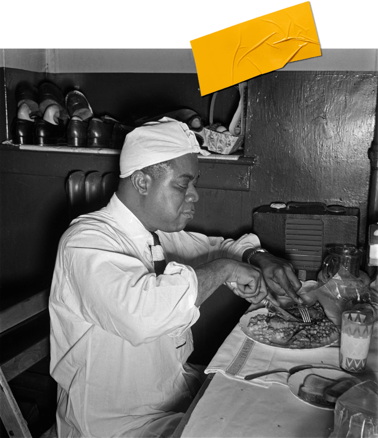 Louis Armstrong enjoying a plate of legumes.