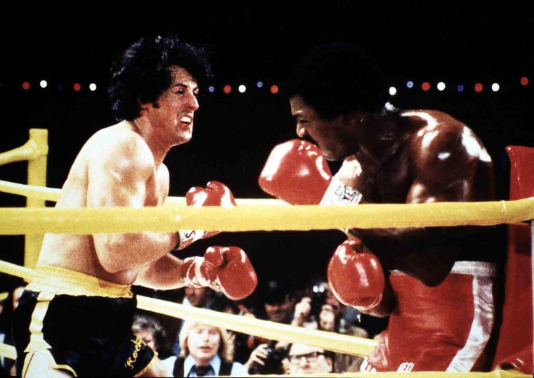 Sylvester Stallone and Carl Weathers as Rocky Balboa and Apollo Creed.