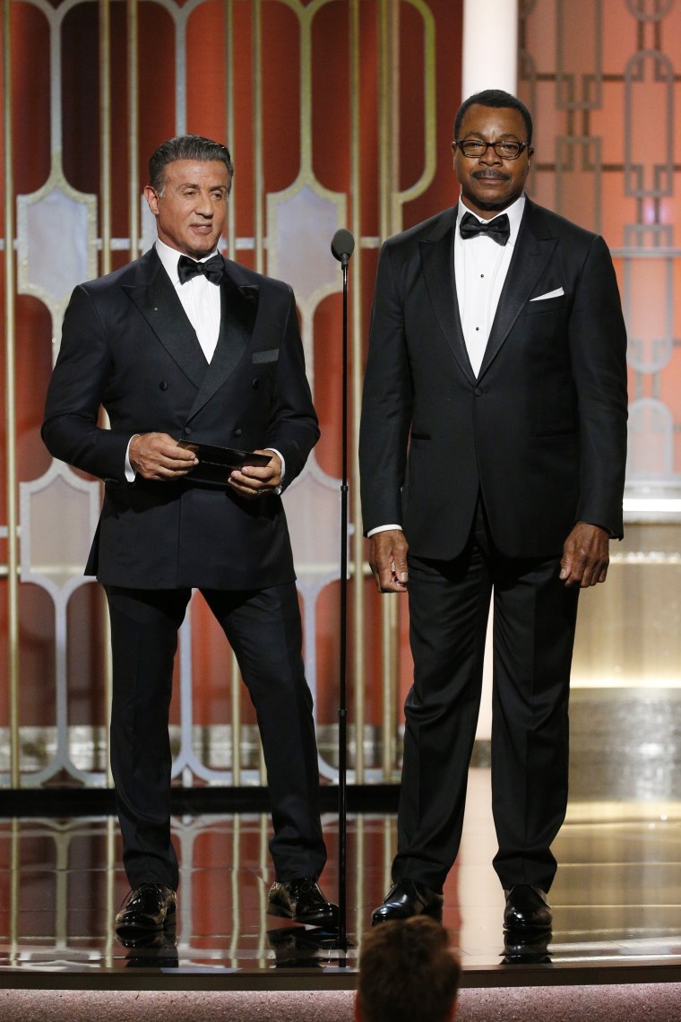 Sylvester Stallone and Carl Weathers, who co-starred in the 1977 Golden Globe Award-winning film "Rocky," present the Golden Globe for best motion picture - drama during the 74th annual Golden Globe Awards at The Beverly Hilton Hotel on Jan. 8, 2017.