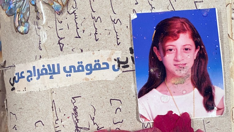 A page of Salma's diary featuring a photograph of her at age 12 and the words "Where are my rights to release me" in Arabic.