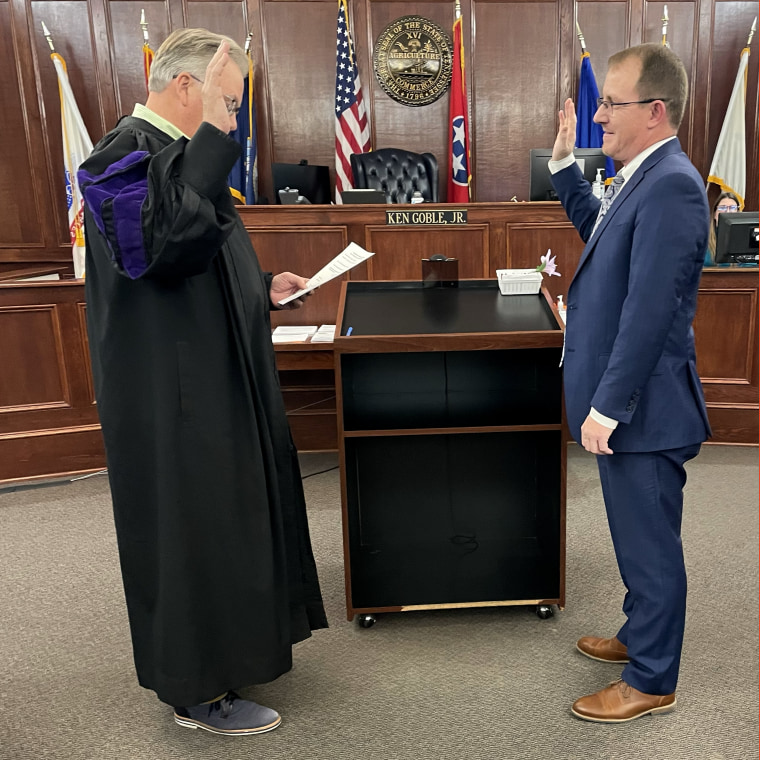 Image: Derek Scott is sworn in by a Judge in a courtoom.