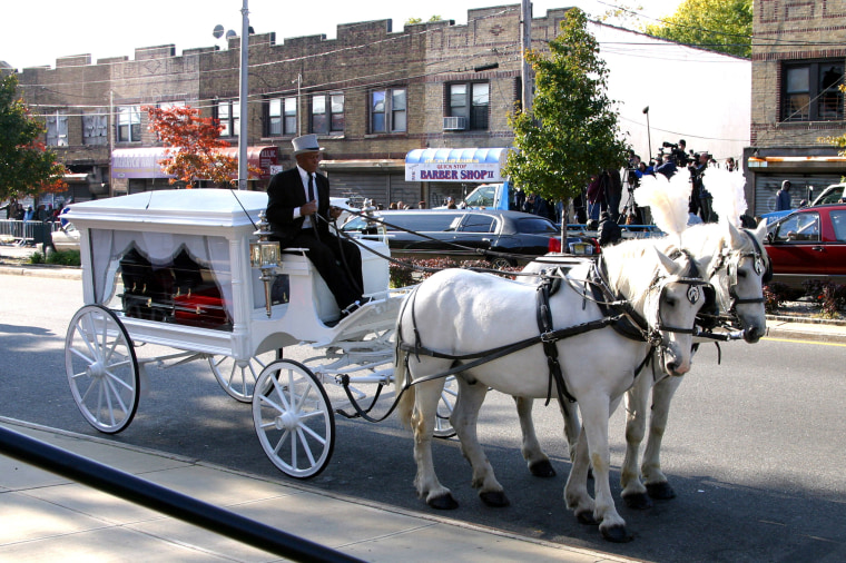 Jam Master Jay coffin in a white horse drawn carriage.