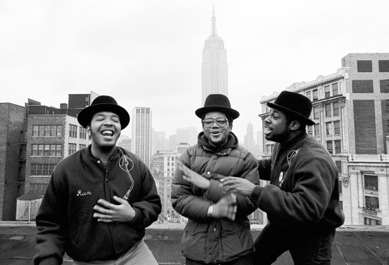 Run-D.M.C. on a rooftop with the Empire State Building in the background.