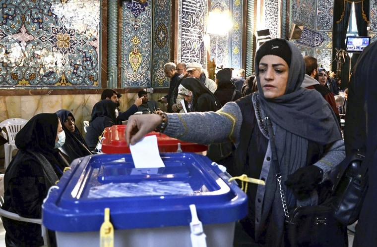 A woman casts her ballot in the Iranian elections in the northern part of Tehran on Friday.