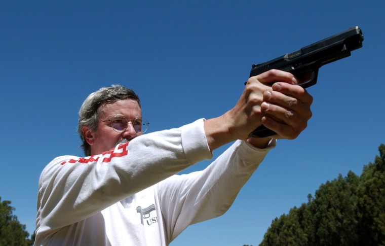 Image: Bruce Gray, a professional shooter, demonstrates how to hold a handgun during a National Shooting Sports Foundation event in 2002.