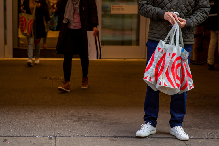 A shopper carries bags outside a Target store 