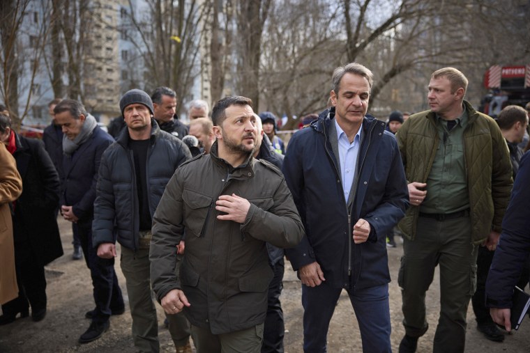 Ukrainian President Volodymyr Zelenskyy, centre left, and Greece's Prime Minister Kyriakos Mitsotakis walk in a place of Russian attack at a residential area on March 2, in Odesa, Ukraine, Wednesday, March 6, 2024. The sound of a large explosion reverberated around the Ukrainian port of Odesa as President Volodymyr Zelenskyy and Greece's prime minister ended a tour of the war-ravaged southern city Wednesday.