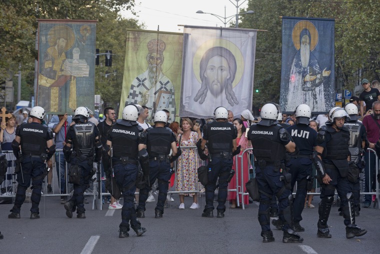 Anti-gay protesters hold religious banners amid heavy police presence at a Pride march in Belgrade, Serbia, on Sept. 9. Greece is becoming the first majority-Orthodox Christian nation to legalize same-sex marriage.