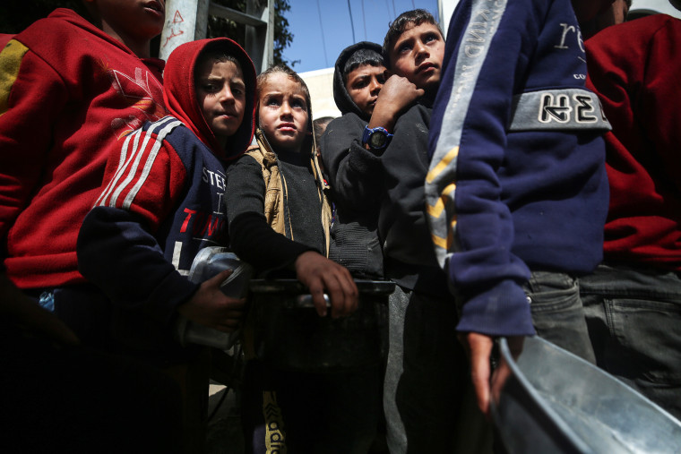 Humanitarian Aid in Gaza: Palestinians Receive Food Rations Amid Conflict