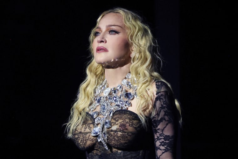 Madonna stands onstage during The Celebration Tour