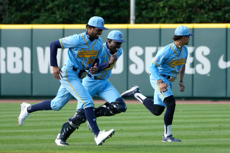 Players run drills before a college baseball game