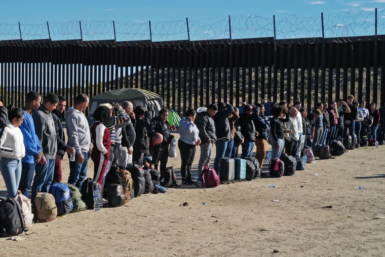 Migrants attempting to cross in to the U.S. from Mexico are detained by U.S. Customs and Border Protection in Jacumba Hot Springs, Calif.