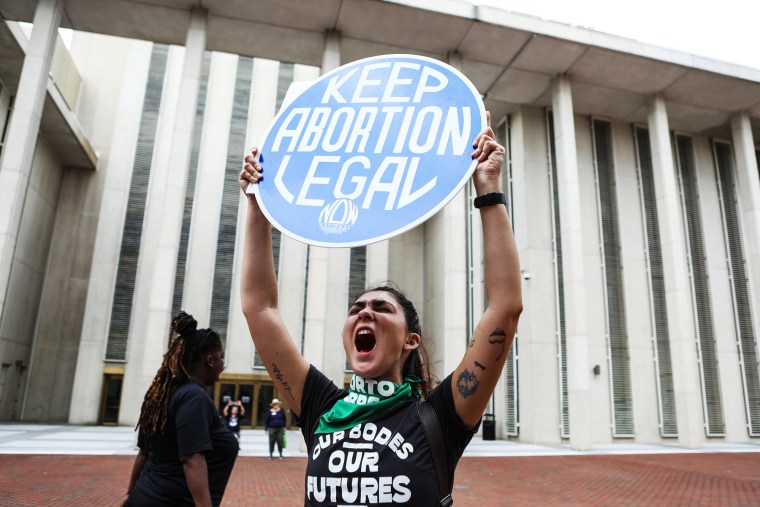 A woman holds a sign that reads "Keep Abortion Legal"