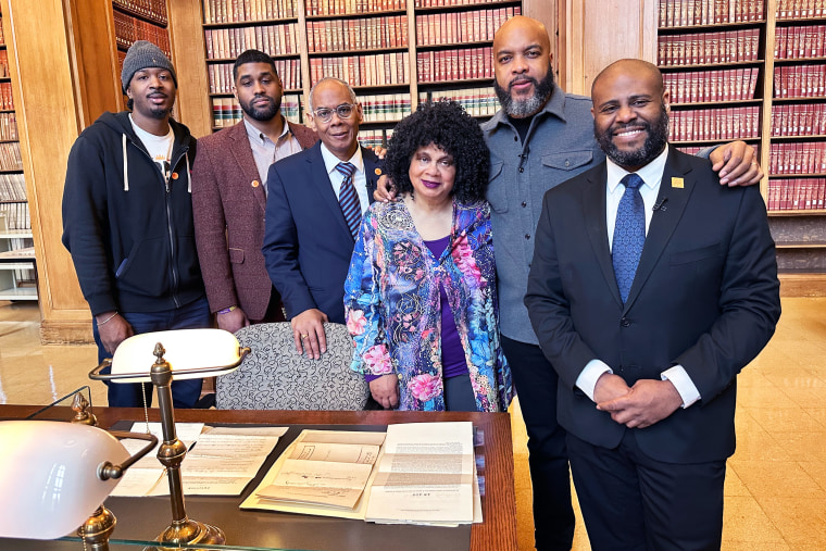 The Coakley descendants visit the original petition by Gabriel Coakley at the National Archives. Left to right: Desmond Flateau-Gooding, Antoine Flateau, Richard Flateau, Adele Flateau, host Trymaine Lee, and archivist Dr. Lopez Matthews.