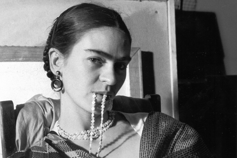 Frida Kahlo biting a necklace