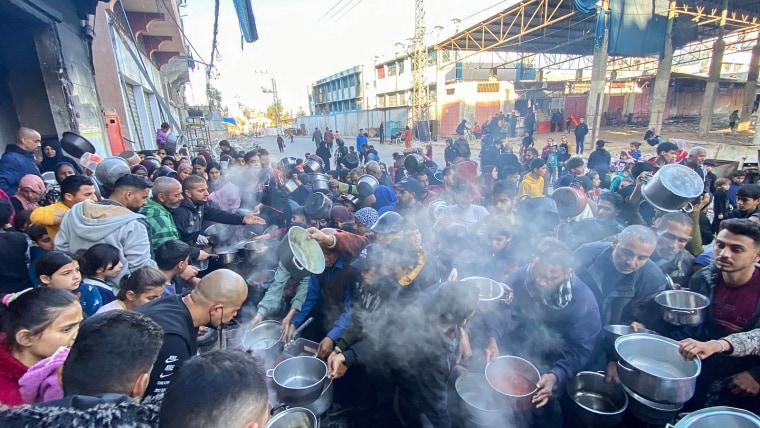 Palestinians gather to collect food from Gaza Soup Kitchen
